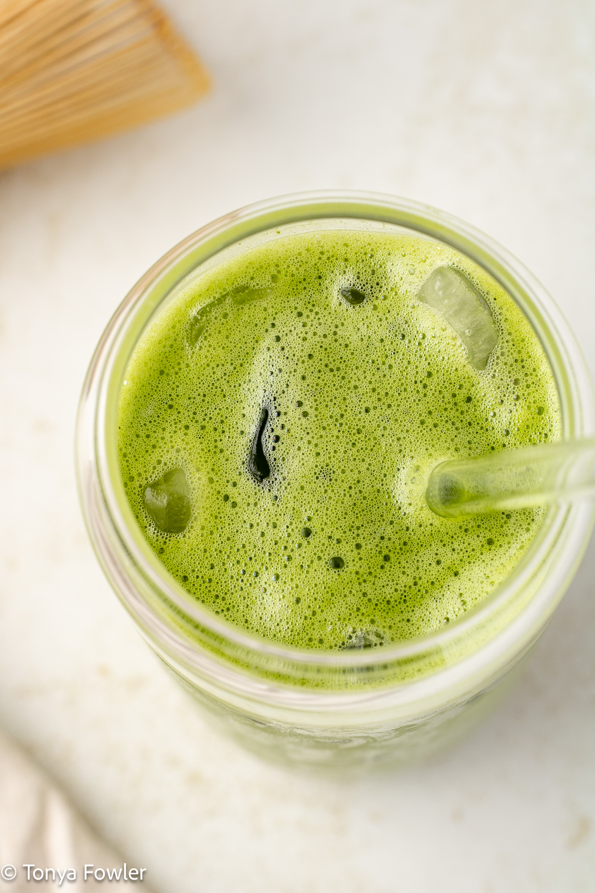 Overhead view of a matcha latte in a glass.