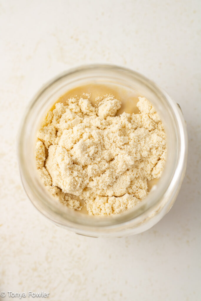 Overhead view of protein powder in a mason jar.