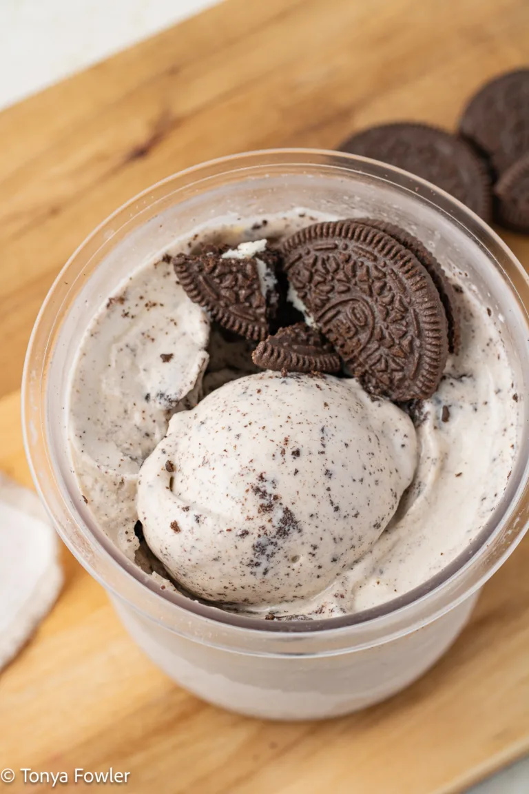 Overhead image of ninja creami cookies and cream protein ice cream in a pint container with oreo cookies.