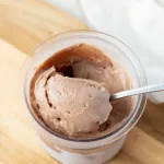A scoop of Ninja creami chocolate protein ice cream in a pint container.
