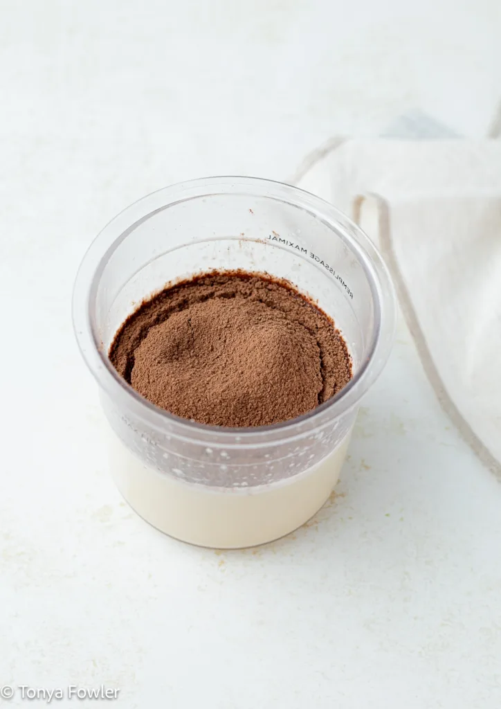 Chocolate powder in a pint container with milk and cream.