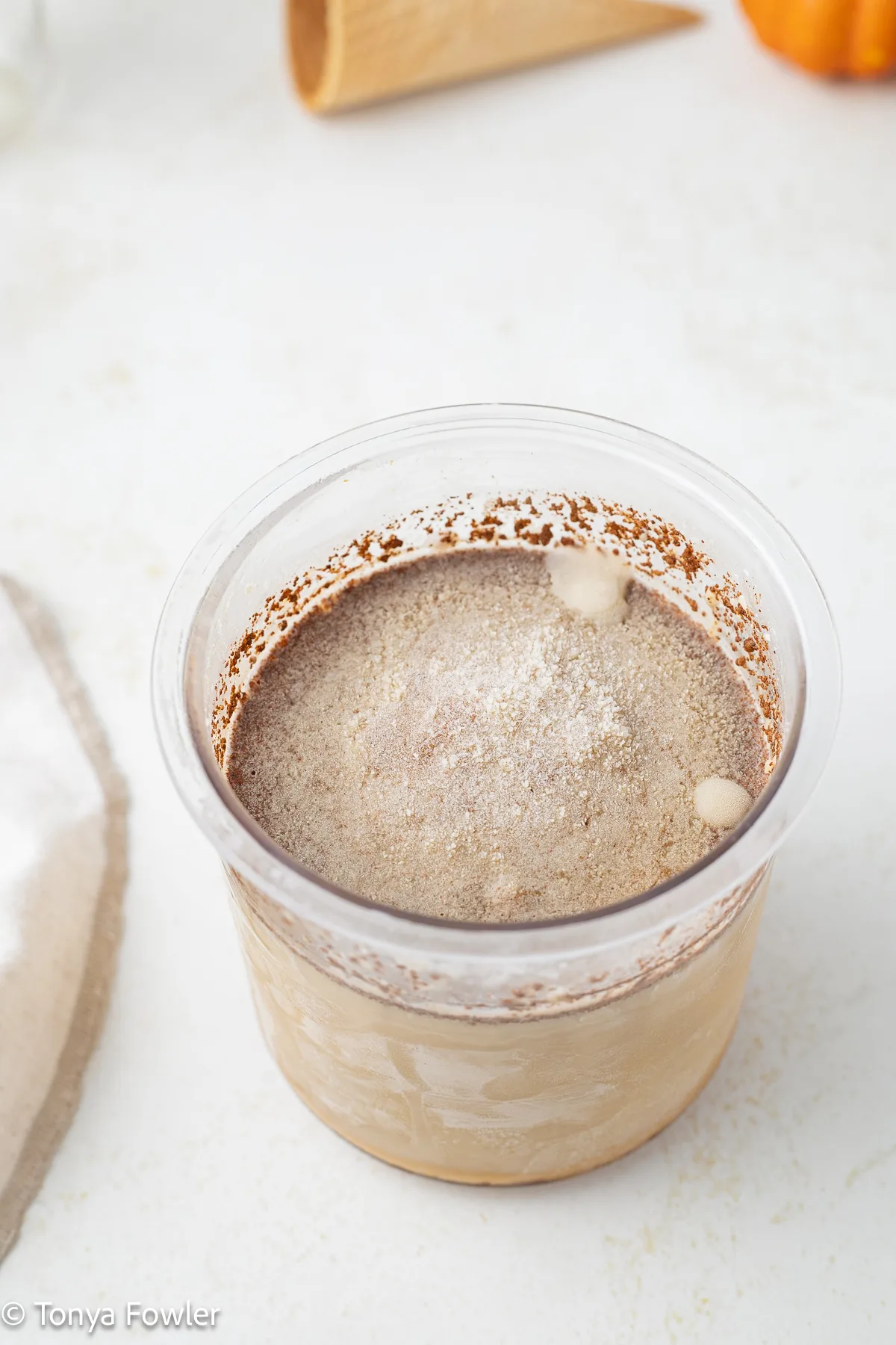 Frozen pumpkin spice ice cream in a pint container.