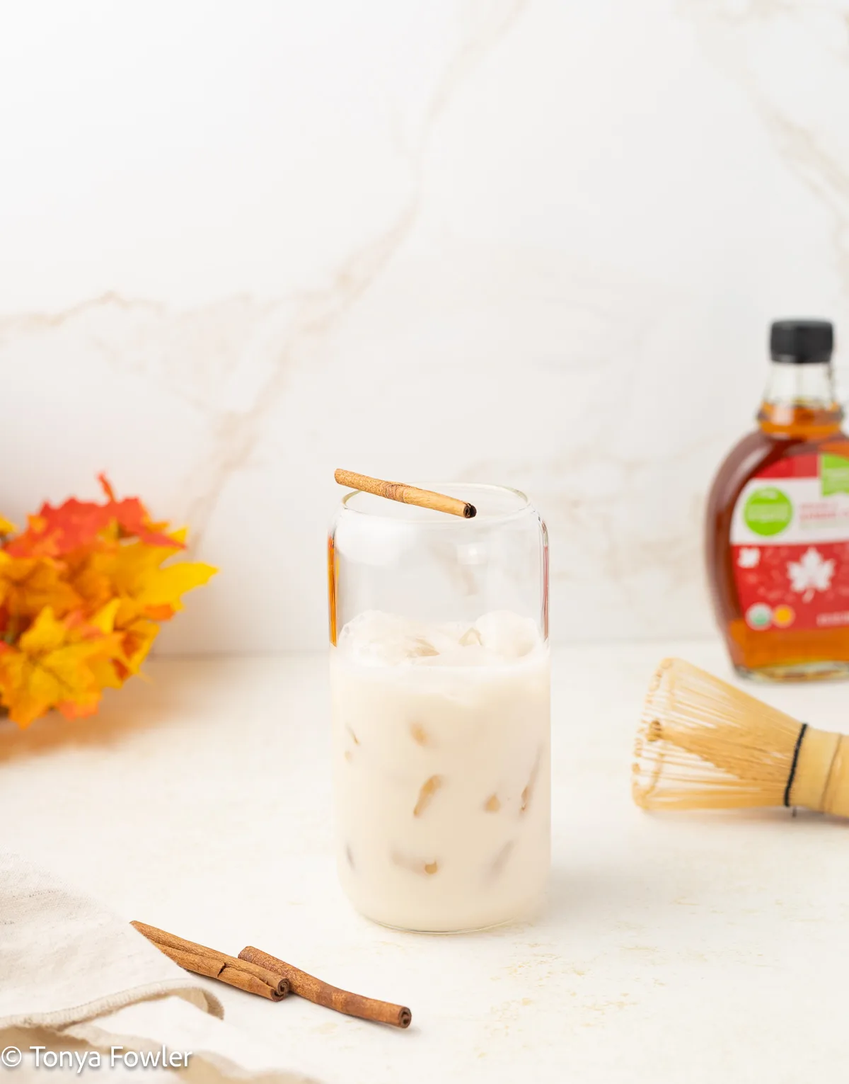 Oat milk in a glass with ice.